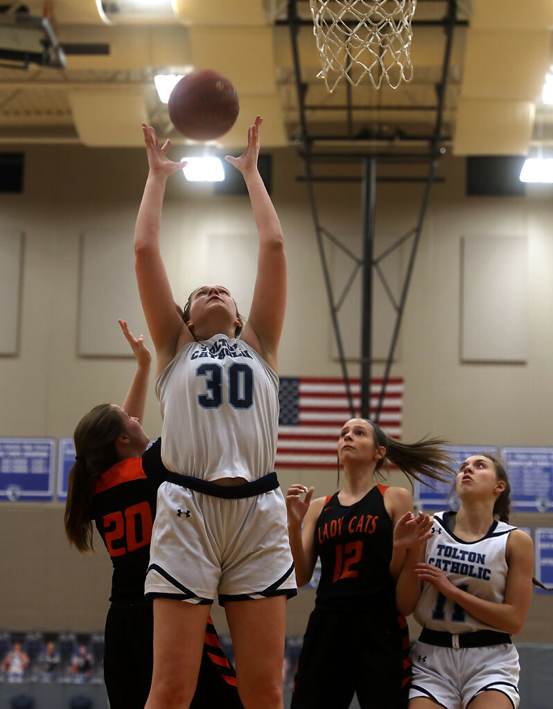 Fr. Tolton High School basketball player Maggie McGuire attempts to grab a rebound